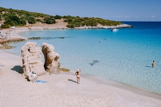 Tropical beach of Voulisma beach, Istron, Crete, Greece ,Most beautiful beaches of Crete island -Istron bay near Agios Nikolaos young asian woman mid age on vacation Greece Crete