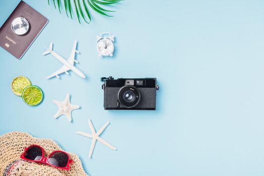 Flat lay top view mockup retro camera films, airplane, starfish, shells, hat traveler tropical accessories on a blue background with copy space, Business trip, and vacation summer travel concept