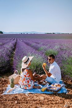 Provence, Lavender field France, Valensole Plateau, colorful field of Lavender Valensole Plateau, Provence, Southern France. Lavender field. Europe. Couple men and woman on vacation at the provence lavender fields,