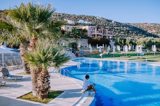 Crete Greece, Candia park village a luxury holiday village in Crete Greece by the ocean in traditional colors. Couple on vacation luxury resort