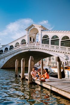 couple men and woman on a city trip to Venice Italy, colorful streets with canals Venice. Europe