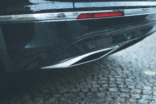 Close up of an exhaust pipe of a car, environmental pollution