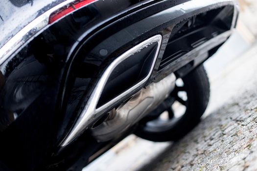 Close up of an exhaust pipe of a car, environmental pollution