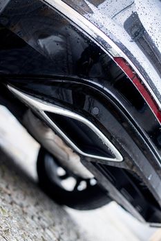 Close up of an exhaust pipe of a car, environmental pollution