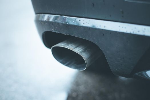 Close up of an exhaust pipe of a car, environmental pollution