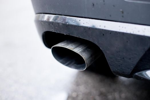 Close up of an exhaust pipe of a car, environmental pollution