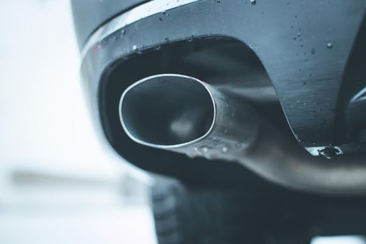 Close up of an exhaust pipe of a car, environmental pollution