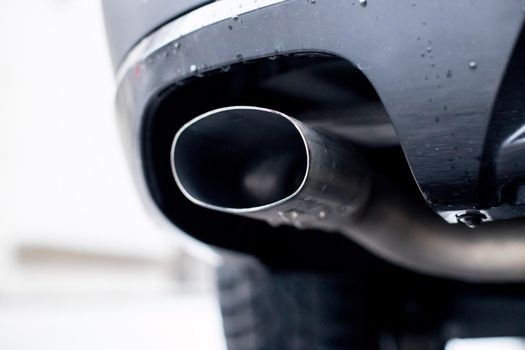 Close up of an exhaust pipe of a car, environmental pollution