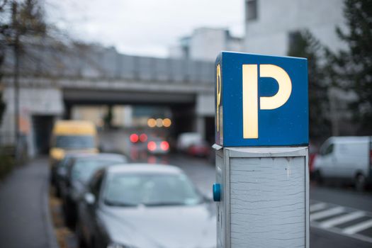 Parking machine in the city street, evening