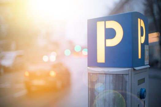 Parking machine in the city street, evening, sunlight.