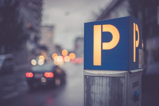 Parking machine in the city street, evening