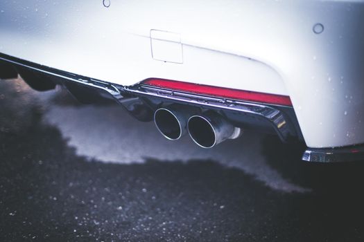 Close up of an exhaust pipe of a car, environmental pollution
