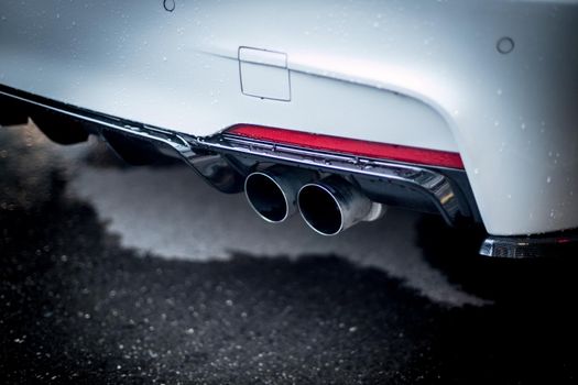 Close up of an exhaust pipe of a car, environmental pollution
