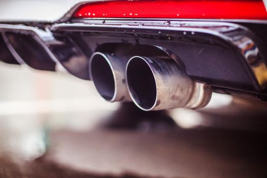 Close up of an exhaust pipe of a car, environmental pollution