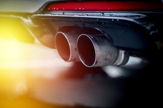 Close up of an exhaust pipe of a car, environmental pollution