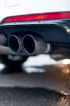 Close up of an exhaust pipe of a car, environmental pollution