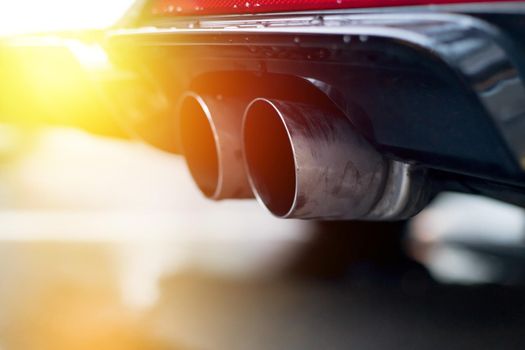 Close up of an exhaust pipe of a car, environmental pollution