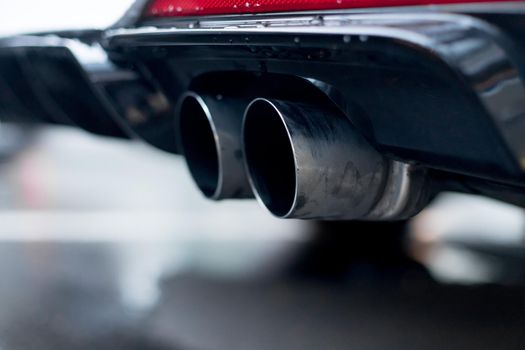 Close up of an exhaust pipe of a car, environmental pollution