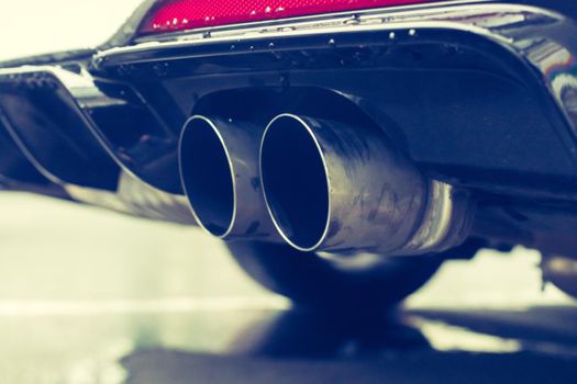 Close up of an exhaust pipe of a car, environmental pollution