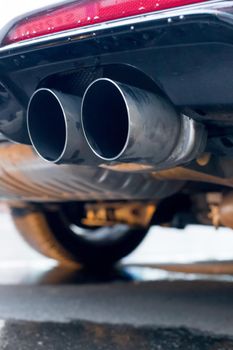 Close up of an exhaust pipe of a car, environmental pollution
