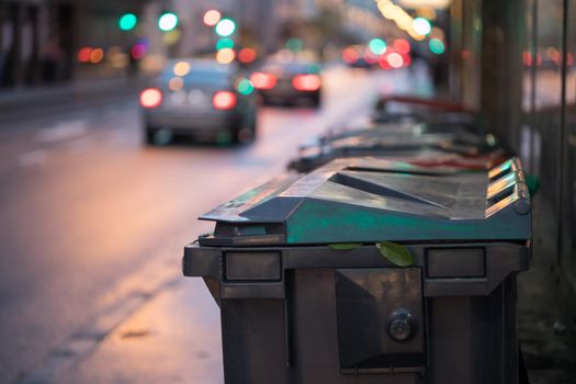 Urban street life with garbage container and street lights