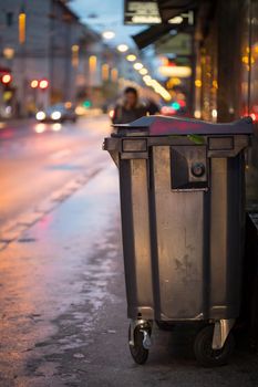 Urban street life with garbage container and street lights