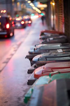 Urban street life with garbage container and street lights