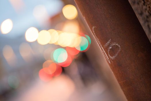 Closeup of rain drain, urban city lights in the blurry background