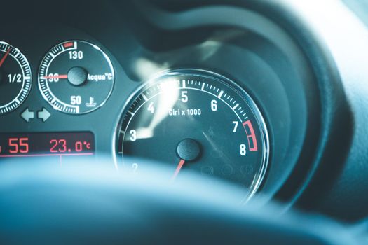 Closeup of the dashboard of a sports car, tachometer and fuel indicator