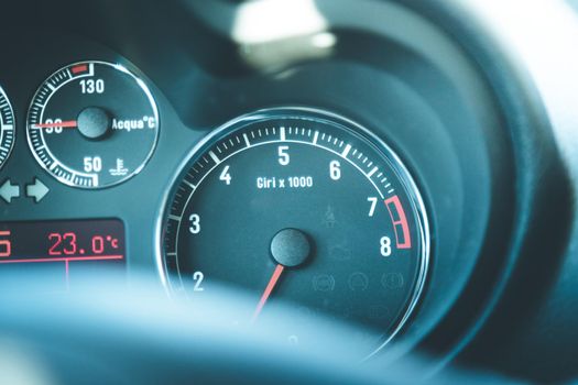 Closeup of the dashboard of a sports car, tachometer and fuel indicator