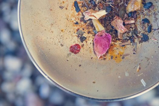 Close up picture of dried incense on a metal bowl