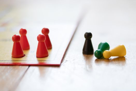 Meeples on a board, ready for playing a parlor game, ludo