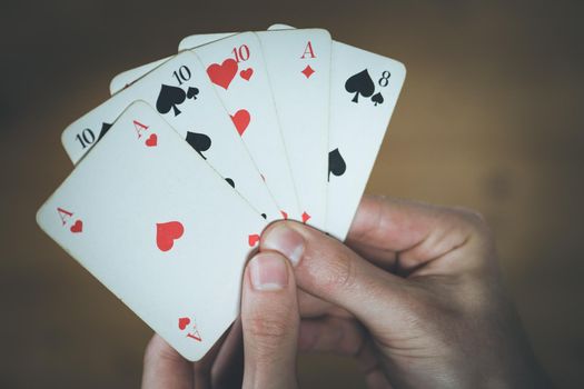 Man is playing cards, cutout of his hands