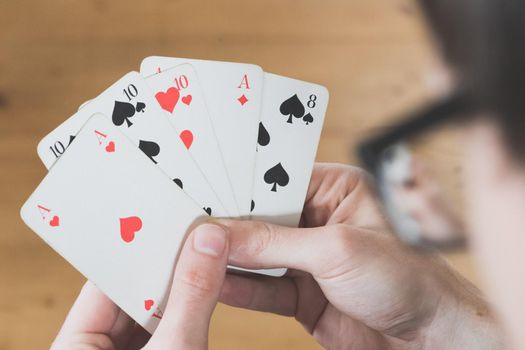 Man is playing cards, cutout of his hands