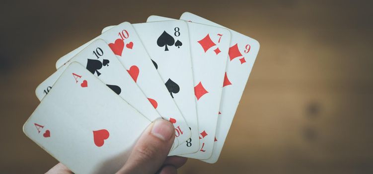 Man is playing cards, cutout of his hands