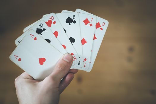 Man is playing cards, cutout of his hands