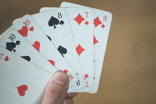 Man is playing cards, cutout of his hands
