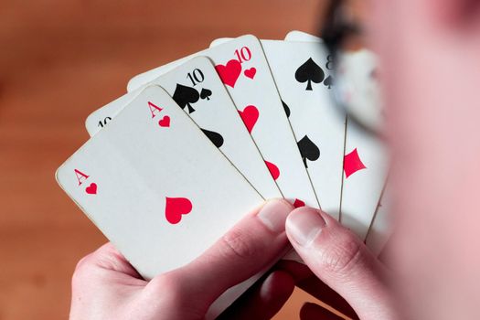 Man is playing cards, cutout of his hands