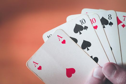 Man is playing cards, cutout of his hands