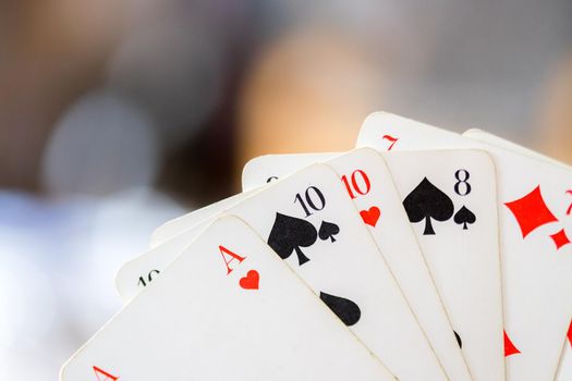 Man is playing cards, cutout of his hands
