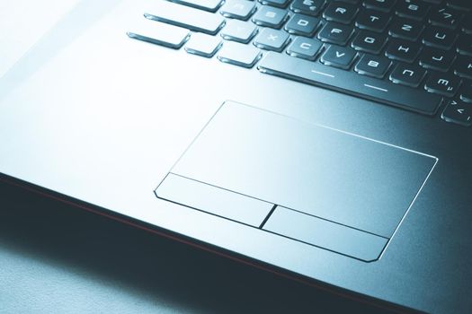 Closeup picture of a black laptop keyboard and touchpad