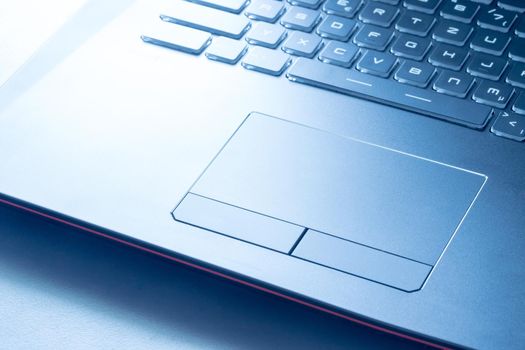 Closeup picture of a black laptop keyboard and touchpad