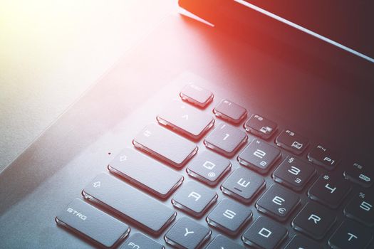 Closeup picture of a black laptop keyboard, Sunshine
