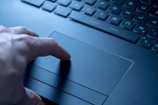 Close up picture of hands using a notebook touchpad