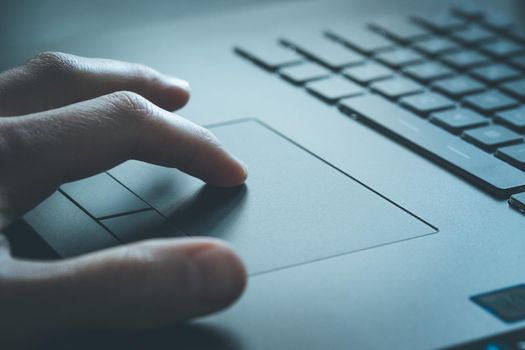 Close up picture of hands using a notebook touchpad