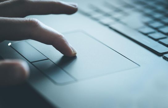 Close up picture of hands using a notebook touchpad
