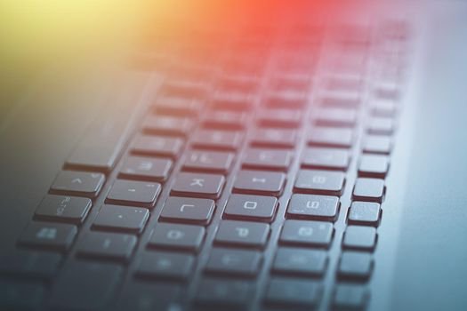 Closeup picture of a black laptop keyboard, Sunshine