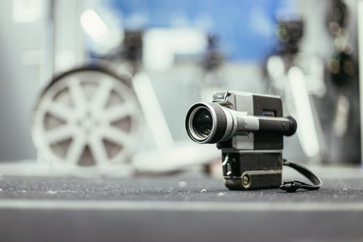 Vintage old movie camera, production studio in the blurry background
