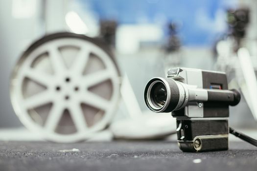 Vintage old movie camera, production studio in the blurry background