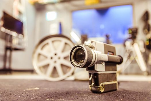 Vintage old movie camera, production studio in the blurry background